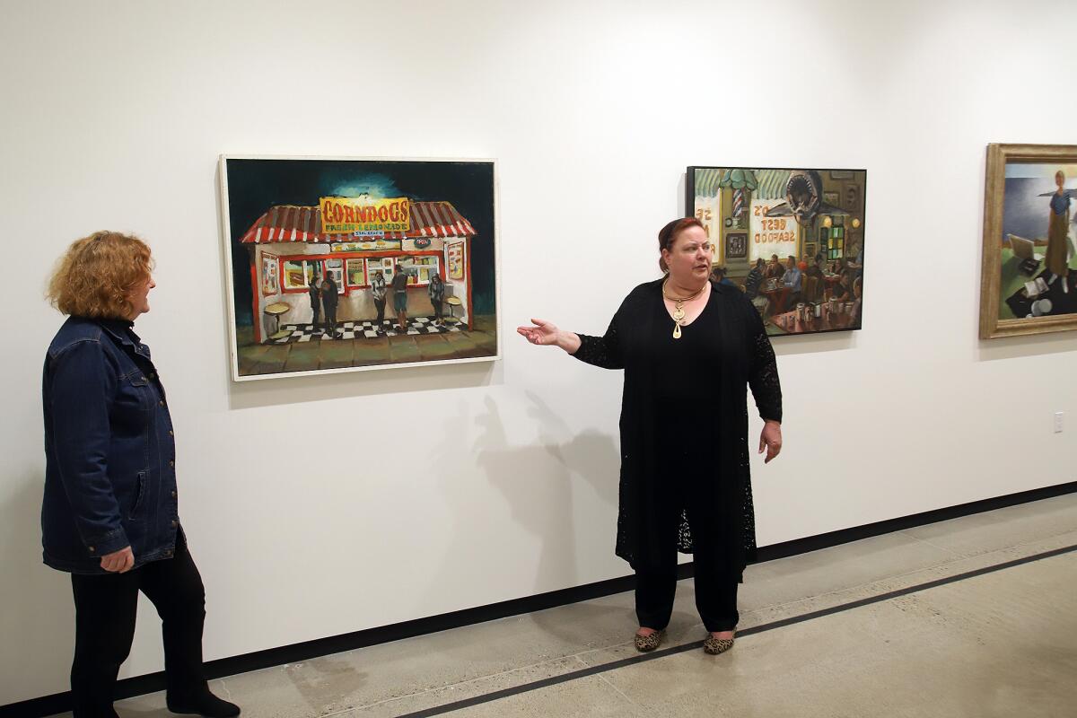 Diane Challis Davy, left, and Mary Platt, with the painting 'Seal Beach Night Hawks' by Bradford J. Salamon.