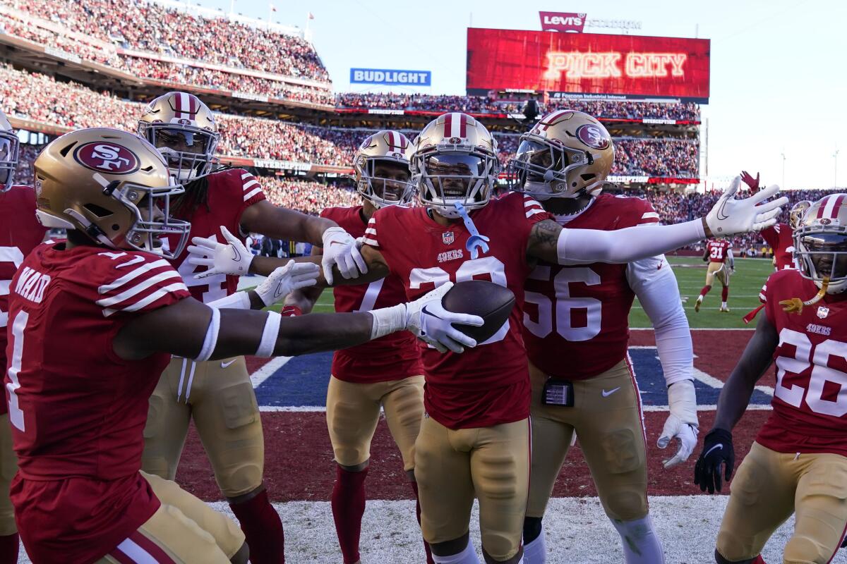 San Francisco cornerback Deommodore Lenoir celebrates after intercepting a pass against the Dallas Cowboys.