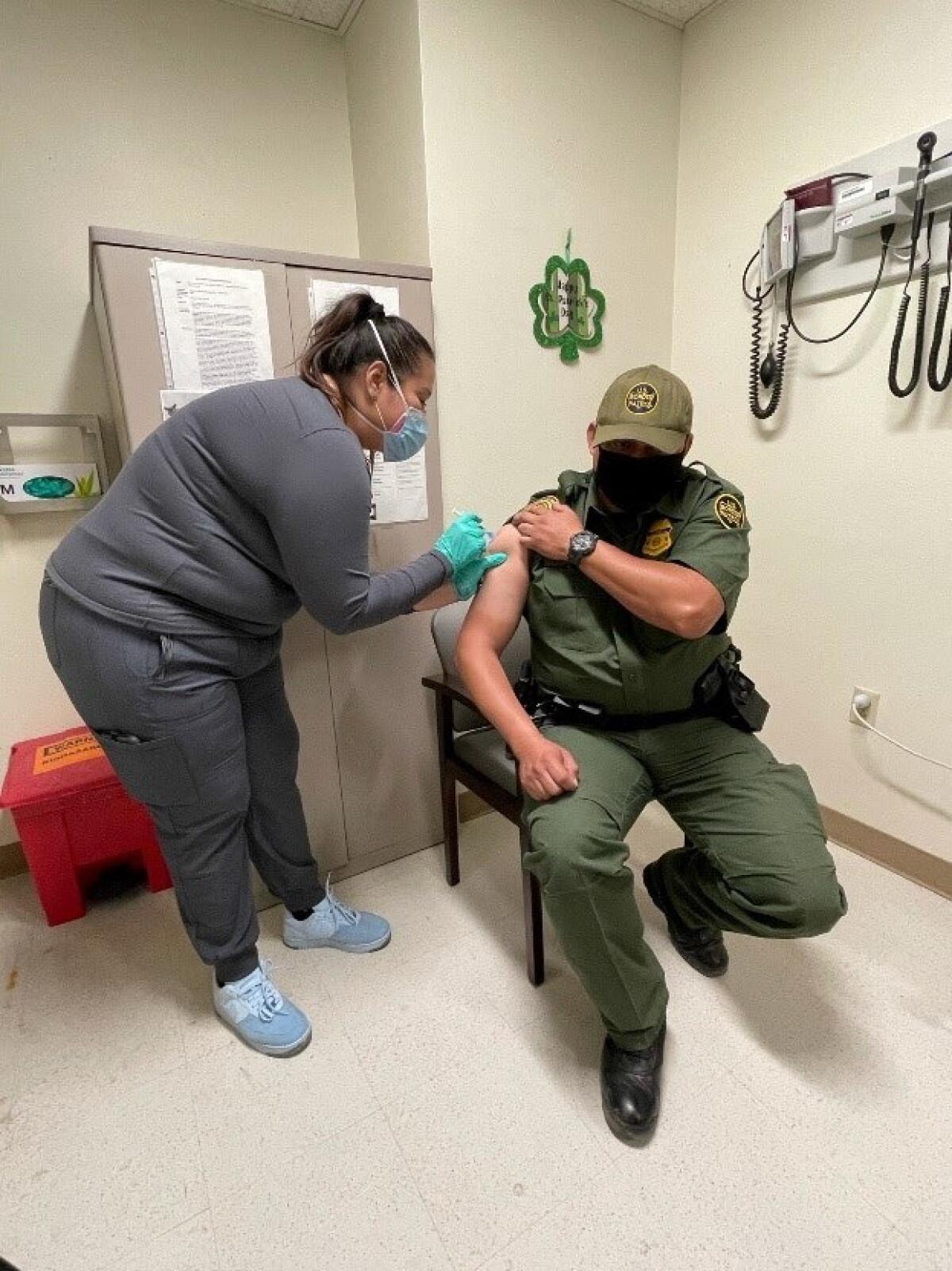 A healthcare worker gives a vaccine