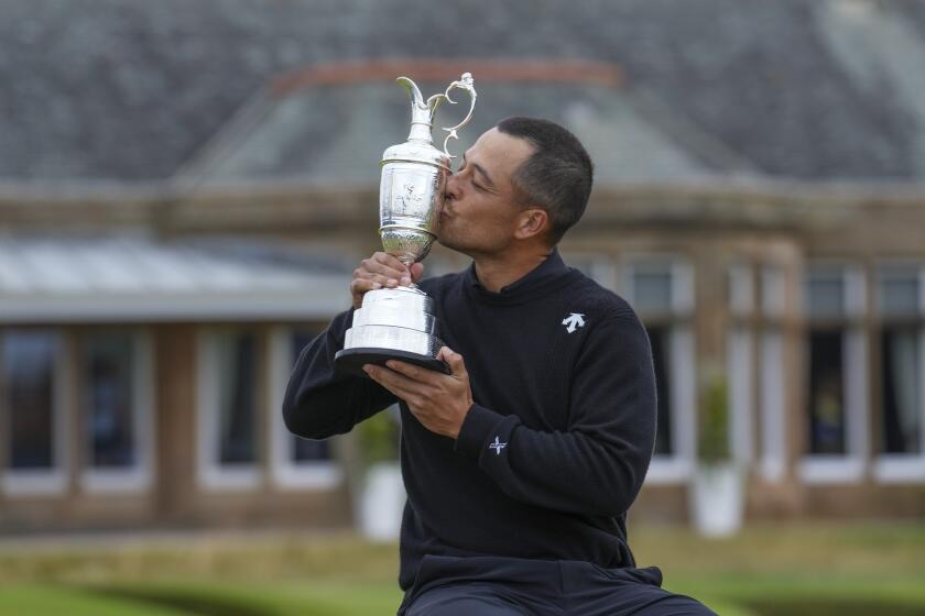 Xander Schauffele of the United States kisses the Claret Jug trophy after winning the British Open Golf Championships at Royal Troon golf club in Troon, Scotland, Sunday, July 21, 2024. (AP Photo/Jon Super)
