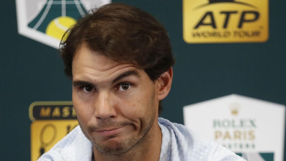 Rafael Nadal of Spain talks to media as he announces his withdraw from the Paris Masters.