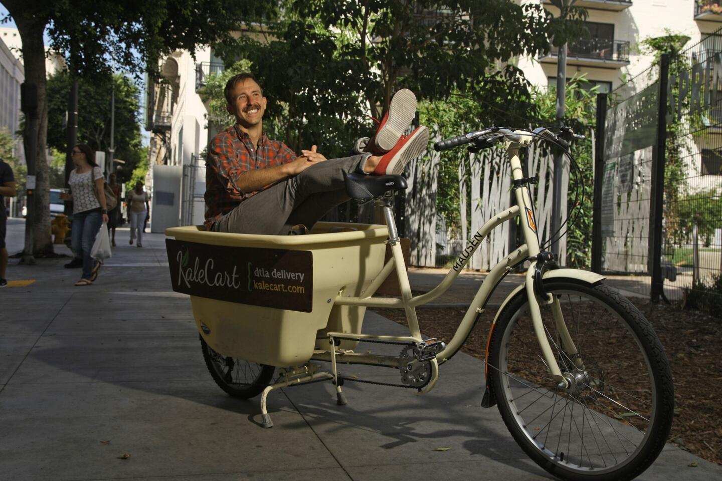 Ryan Matteson of Kale Cart uses a bike with trailer for deliveries in downtown L.A. The service relies solely on bicycles to bring customers their goods.