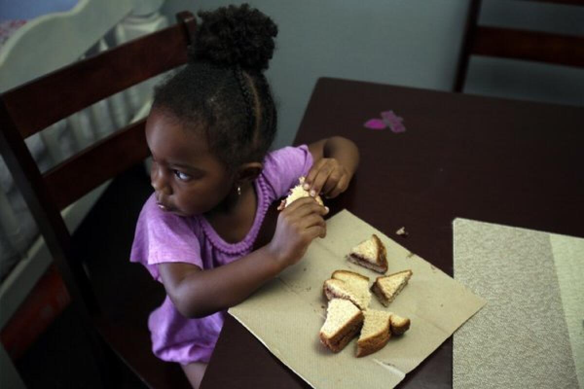 Does Congress care about her? Answer: No. Ausara Mudahy, 2, whose mother works two jobs and receives food stamp assistance, at the dinner table in Culver City.