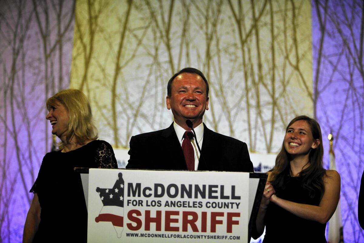 Long Beach Police Chief Jim McDonnell, shown with his wife, Kathy, and daughter, Megan, is widely seen as the frontrunner in the November runoff election for Los Angeles County sheriff.
