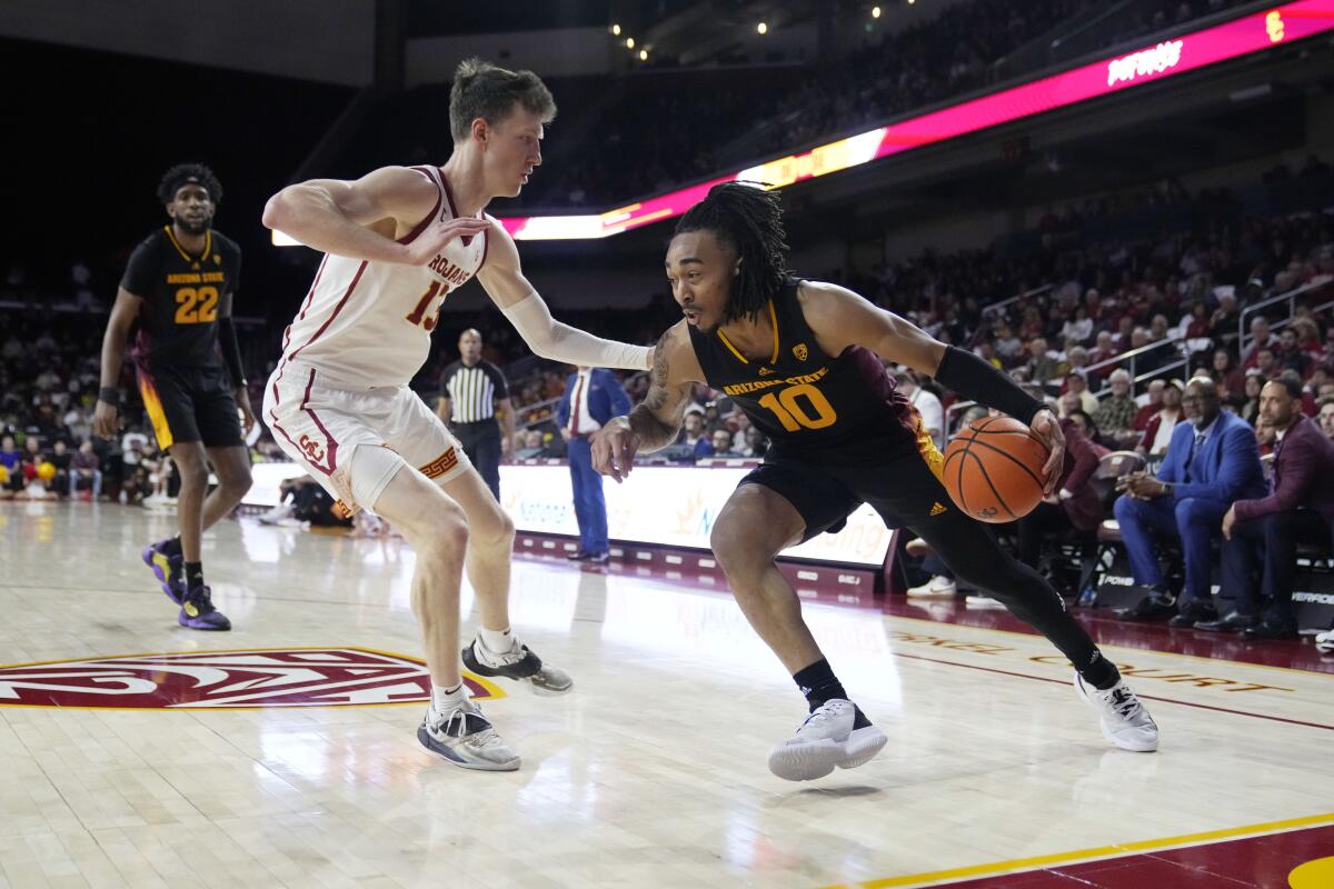 USC's Drew Peterson guards an Arizona State player.