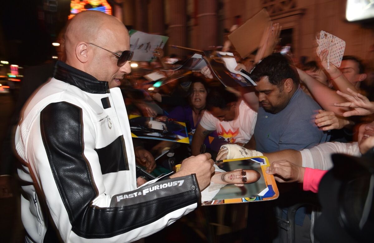 Vin Diesel signs autographs at the premiere of "Furious 7" at the TCL Chinese Theatre Imax on Wednesday.