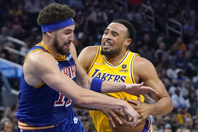 Los Angeles Lakers guard Talen Horton-Tucker, right, is fouled by Golden State Warriors guard Klay Thompson.