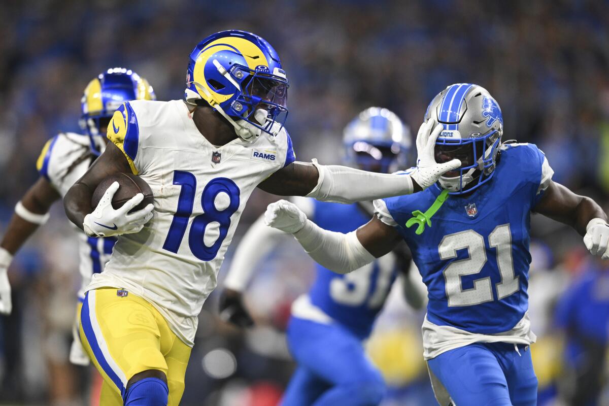 Rams wide receiver Tyler Johnson stiff-arms Detroit Lions cornerback Amik Robertson on a 63-yard reception on Sept. 8.