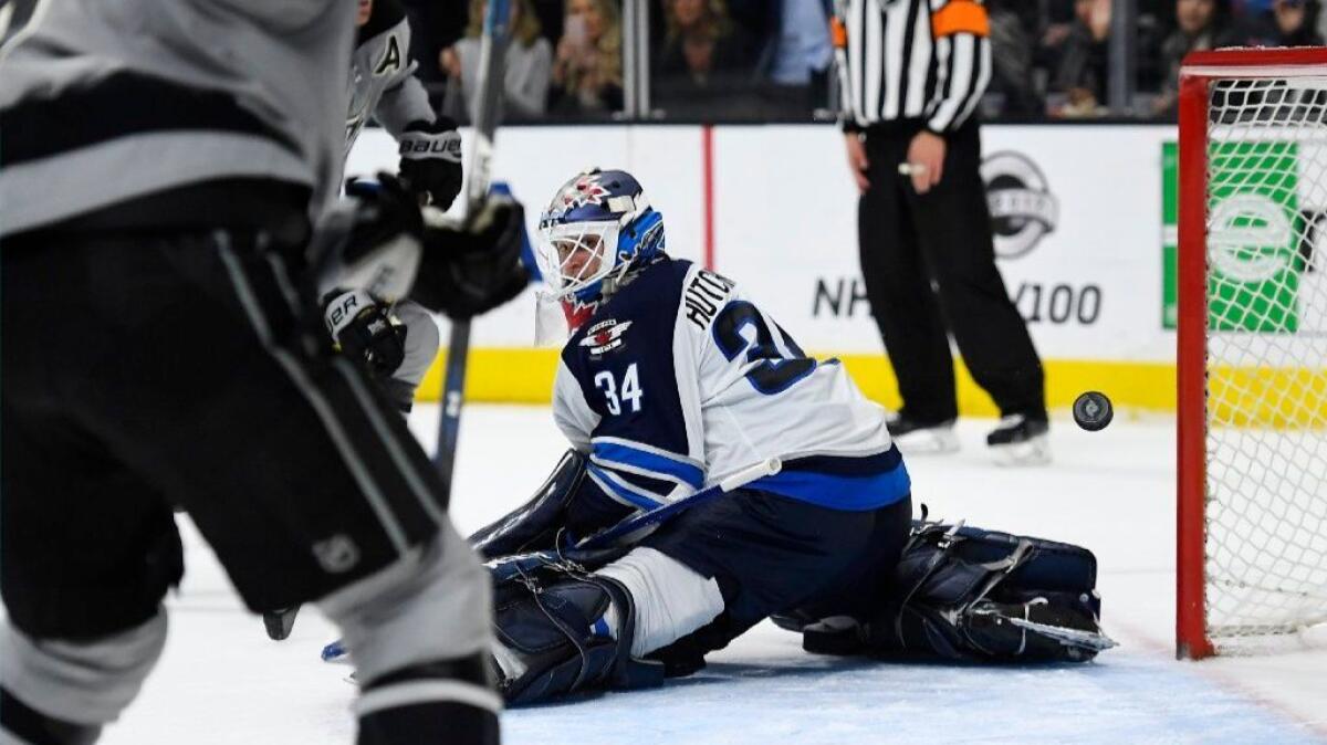 Winnipeg goaltender Michael Hutchinson watches as the puck sails into the net off the stick of Kings forward Jeff Carter in overtime.