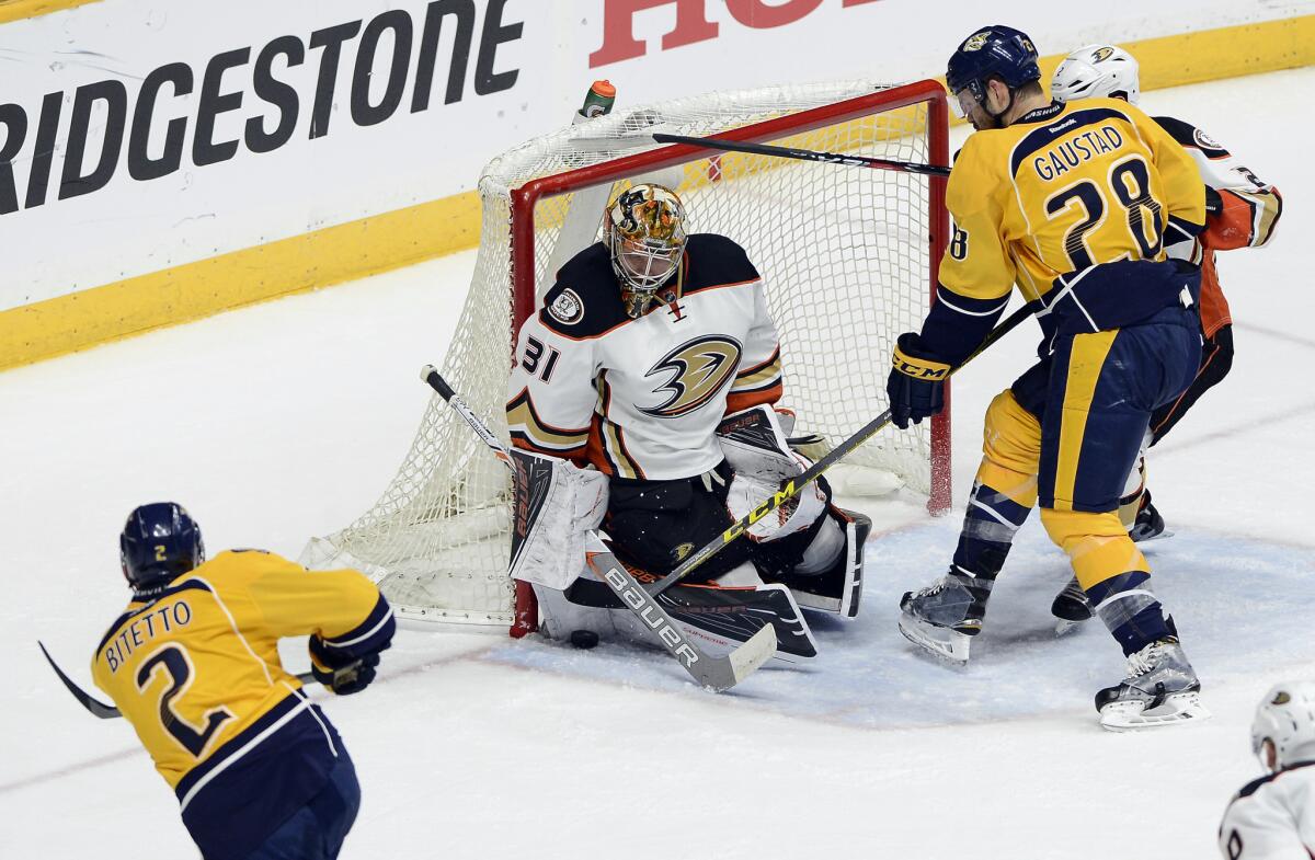 Ducks goalie Frederik Andersen blocks a shot by Nashville's Anthony Bitetto, left, as Predators center Paul Gaustad looks for the rebound.