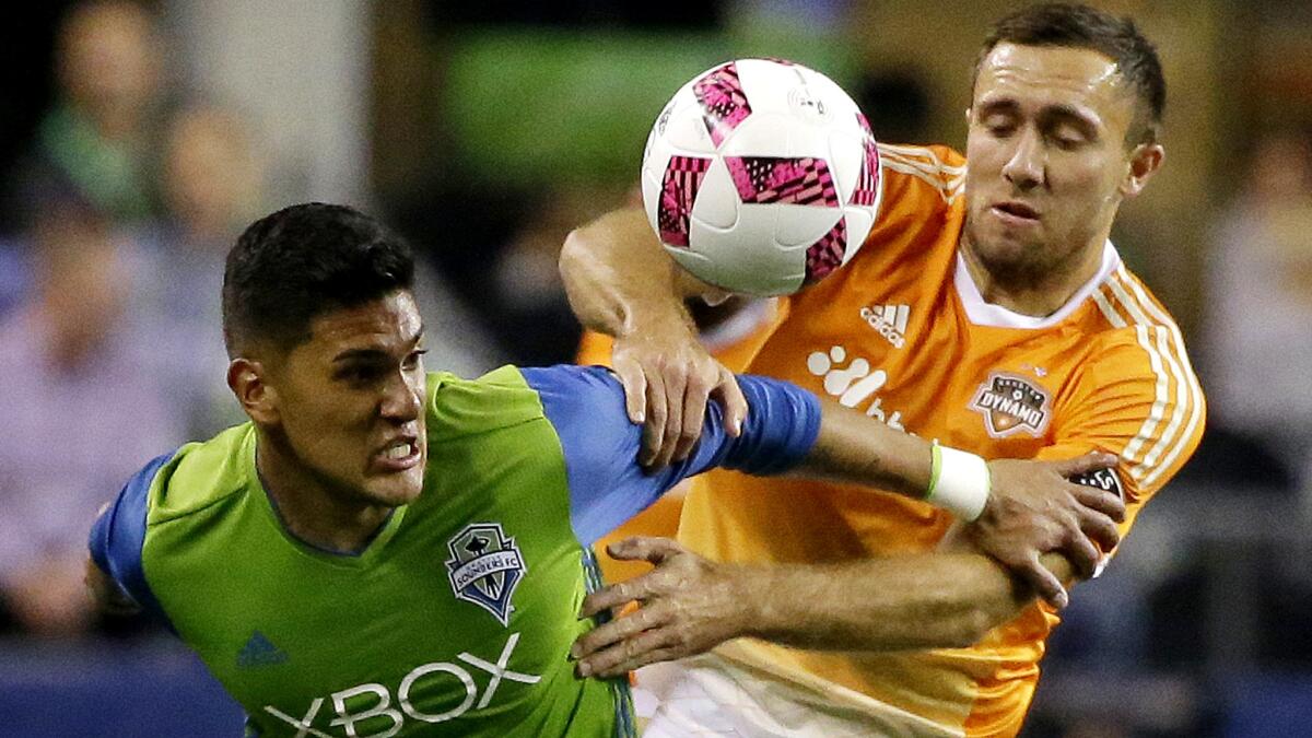 Andrew Wenger, right, and the Houston Dynamo played Tony Alfaro and the Sounders to a 0-0 draw on Wednesday, hurting Seattle's postseason chances.
