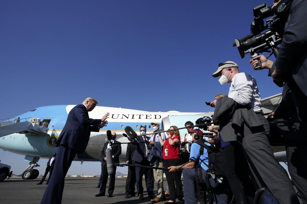 President Trump speaks to reporters Monday at Phoenix Sky Harbor International Airport.
