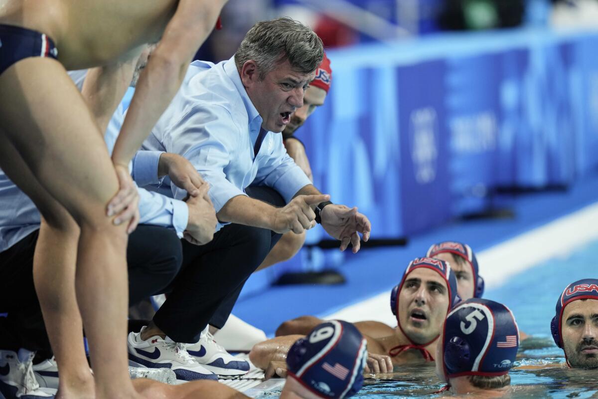 U.S. coach Dejan Udovicic talks to the players during a break in their semifinal match against Serbia on Friday.