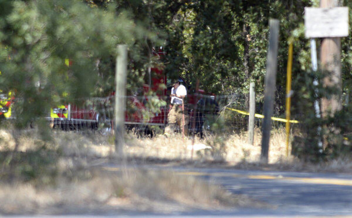 A paramedic with the Vacaville Fire Department walks near a crime scene along Cherry Glen Road where Sandra Coke's body was discovered.