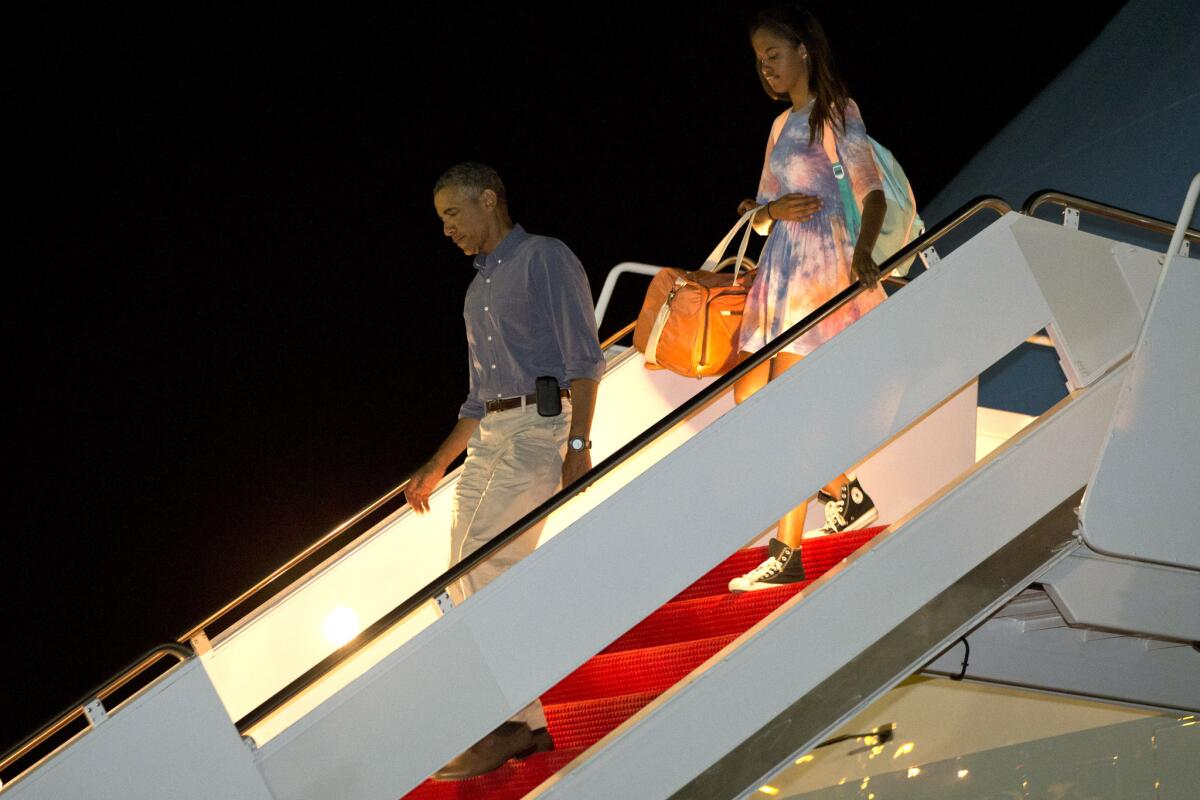 President Obama and daughter Malia Obama step off Air Force One after arriving at Andrews Air Force Base outside Washington on Monday. The president took a short hiatus from his family vacation on Martha's Vineyard to attend meetings at the White House.