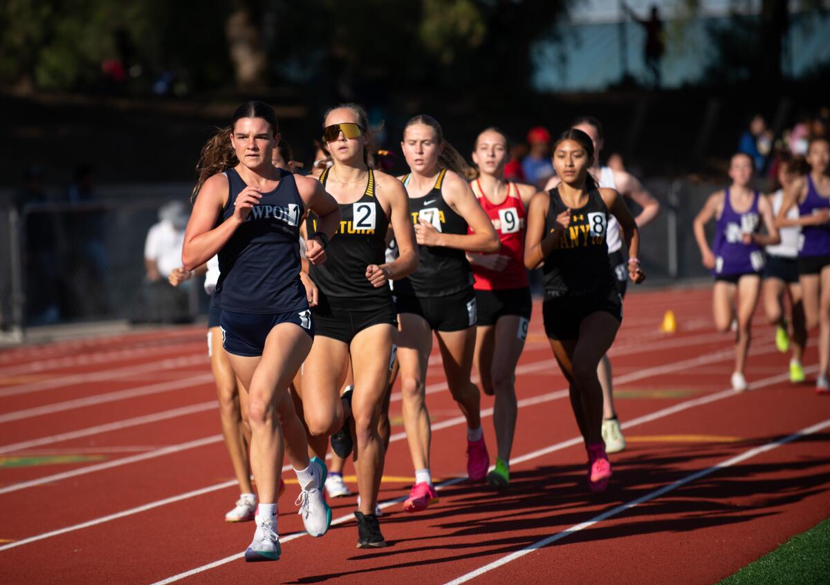 Newport Harbor's Marley McCullough, left, leads her competition in the 3,200 meters during the CIF track and field finals.
