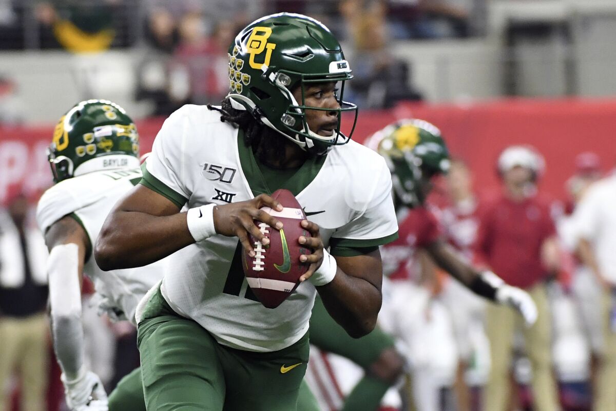 FILE - In this Dec. 7, 2019, file photo, Baylor quarterback Gerry Bohanon (11) rolls out to pass against Oklahoma during the first half of an NCAA college football game for the Big 12 Conference championship in Arlington, Texas. Bohanon is getting his chance as Baylor’s starting quarterback after 3 and half seasons on campus. He starts when the Bears open their season Saturday night at Texas State. (AP Photo/Jeffrey McWhorter, File)