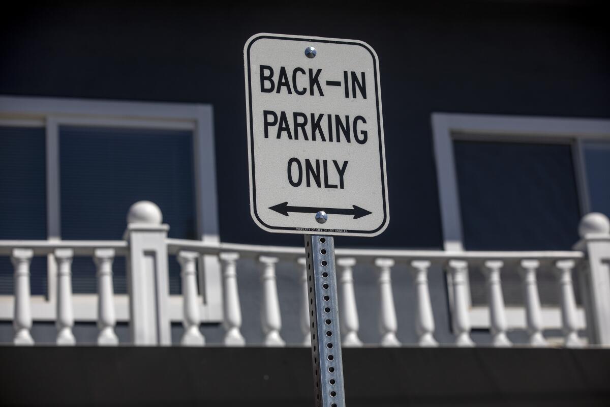 A sign says "Back-in parking only."