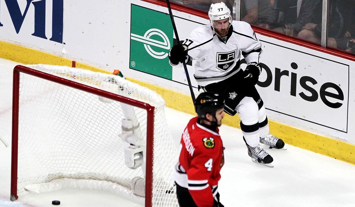 Kings forward Jeff Carter celebrates after scoring one of his three goals in the third period against defenseman Niklas Hjalmarsson and the Blackhawks on Wednesday night in Chicago.