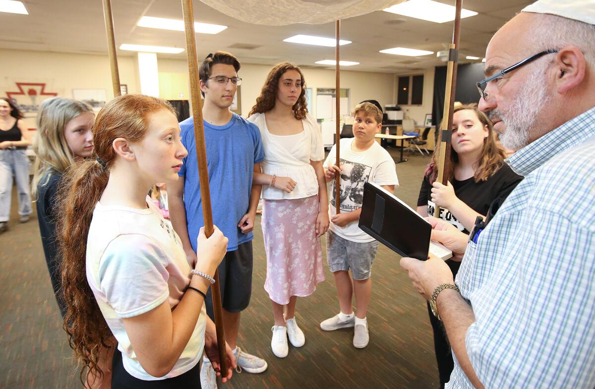 Steven Harvey Hirsch, right, plays a rabbi in a wedding scene from "I Never Saw Another Butterfly" during a rehearsal at the Boys & Girls Club of Laguna Beach.