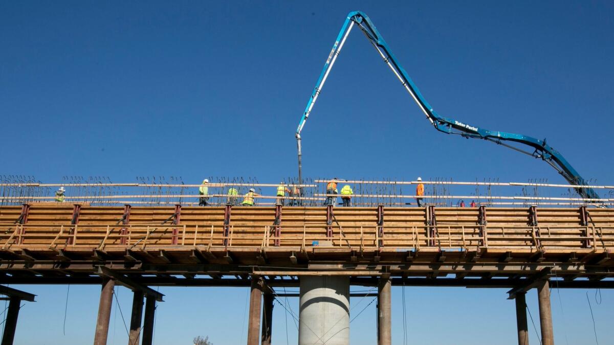 Workers pour concrete Dec. 6 on an elevated section of the high-speed rail line that will cross over the San Joaquin River, near Fresno.