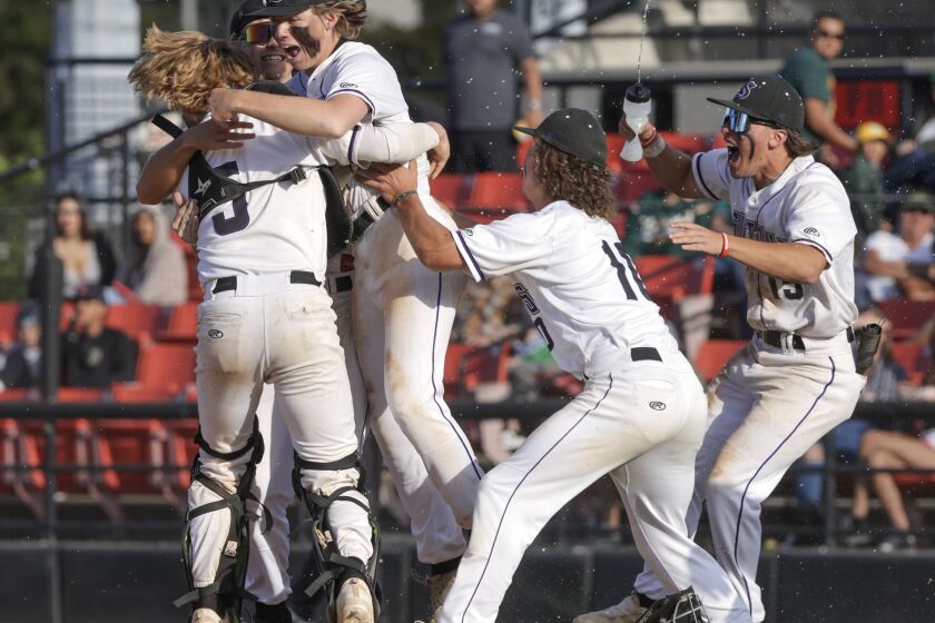 SAN DIEGO, CA - MAY 26, 2023: Santana pitcher Destin Allen-Fox, third from left, and fellow teammates celebrate after Santana defeated Patrick Henry 8-0 to win the CIF-San Diego Section Division I championship at Tony Gwynn Stadium in San Diego on Friday, May 26, 2023. (Hayne Palmour IV / For The San Diego Union-Tribune)