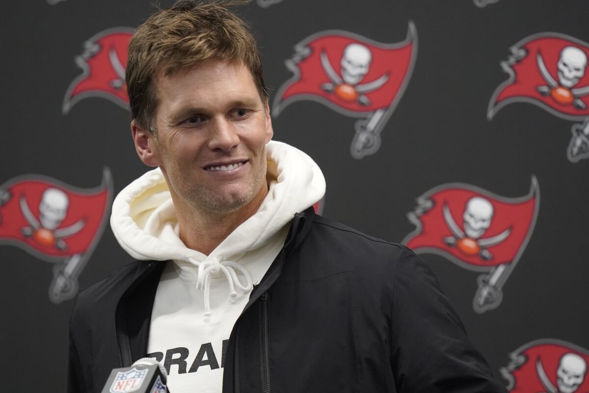 Tampa Bay Buccaneers quarterback Tom Brady smiles while talking with reporters after defeating the New England Patriots 19-17 in an NFL football game, Monday, Oct. 4, 2021, in Foxborough, Mass. (AP Photo/Steven Senne)
