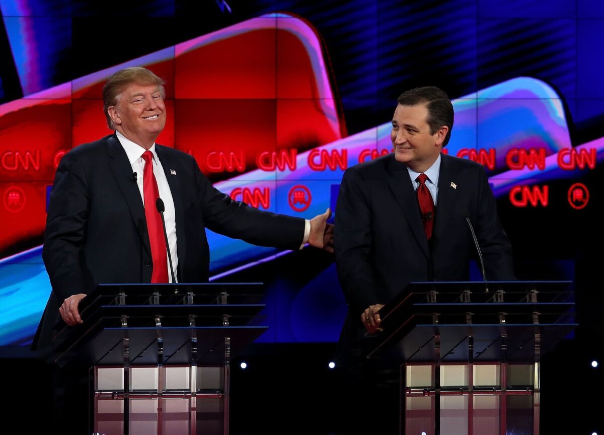 Republican presidential candidates Donald Trump and Sen. Ted Cruz interact during the CNN Republican presidential debate in Las Vegas on Dec. 15.