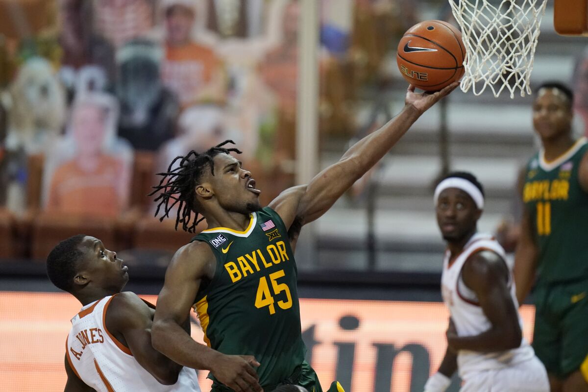 Baylor guard Davion Mitchell drives to the basket past Texas guard Andrew Jones.