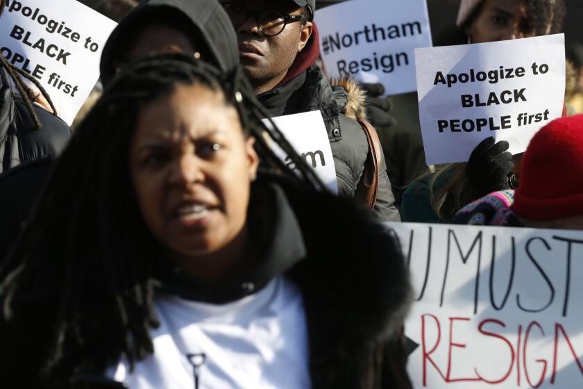 Demonstrators hold signs and chant outside the Governors Mansion at the Capitol in Richmond, Va., Saturday, Feb. 2, 2019. The demonstrators are calling for the resignation of Virginia Governor Ralph Northam after a 30 year old photo of him on his medical school yearbook photo was widely distributed Friday. (AP Photo/Steve Helber)