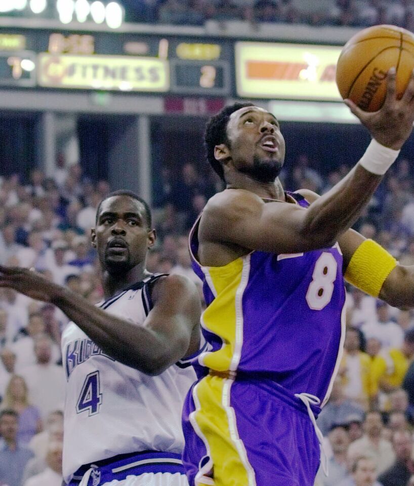 Chris Webber of the Sacramento Kings, left, and Kobe Bryant, going up with the ball.