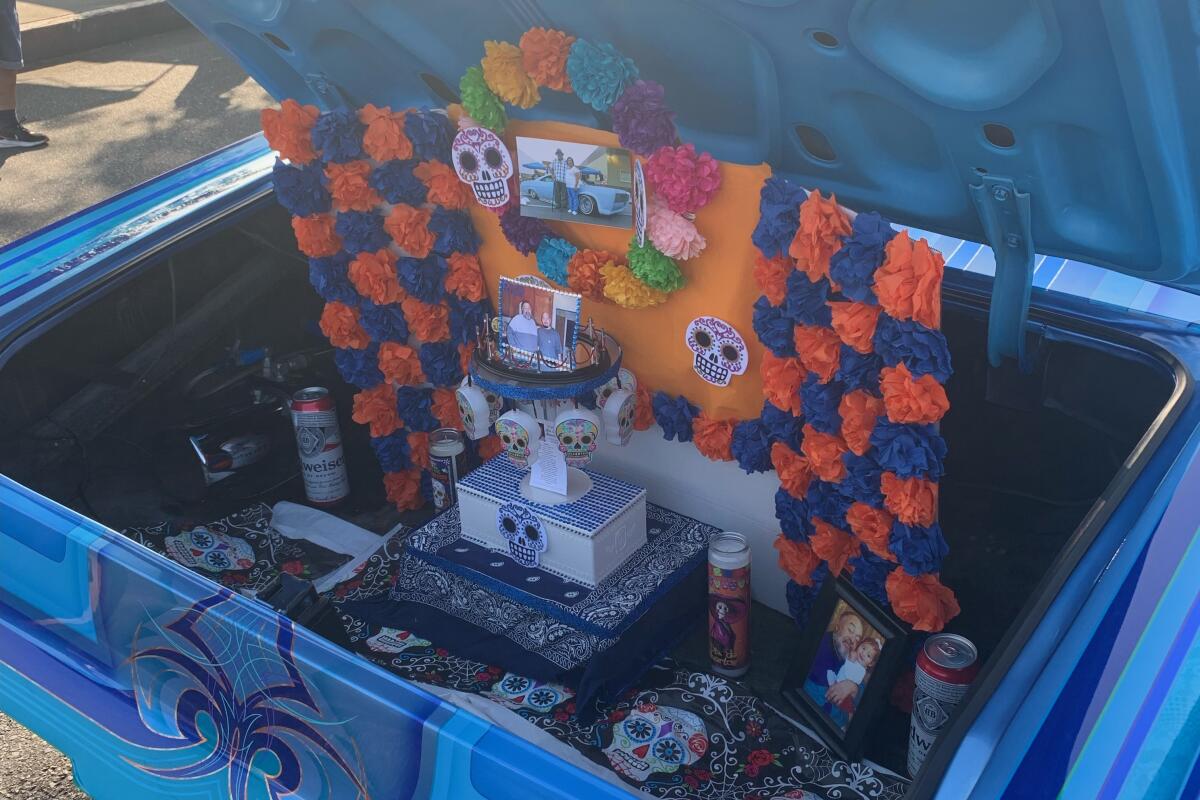Altar in the trunk of a blue car. 