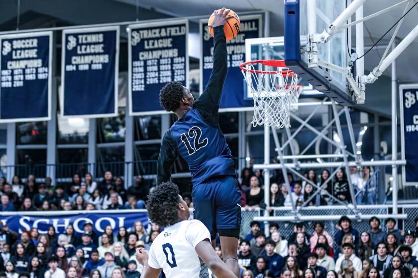 Bryce Cofield of Sierra Canyon skies for a dunk against St. John Bosco's Brandon McCoy.