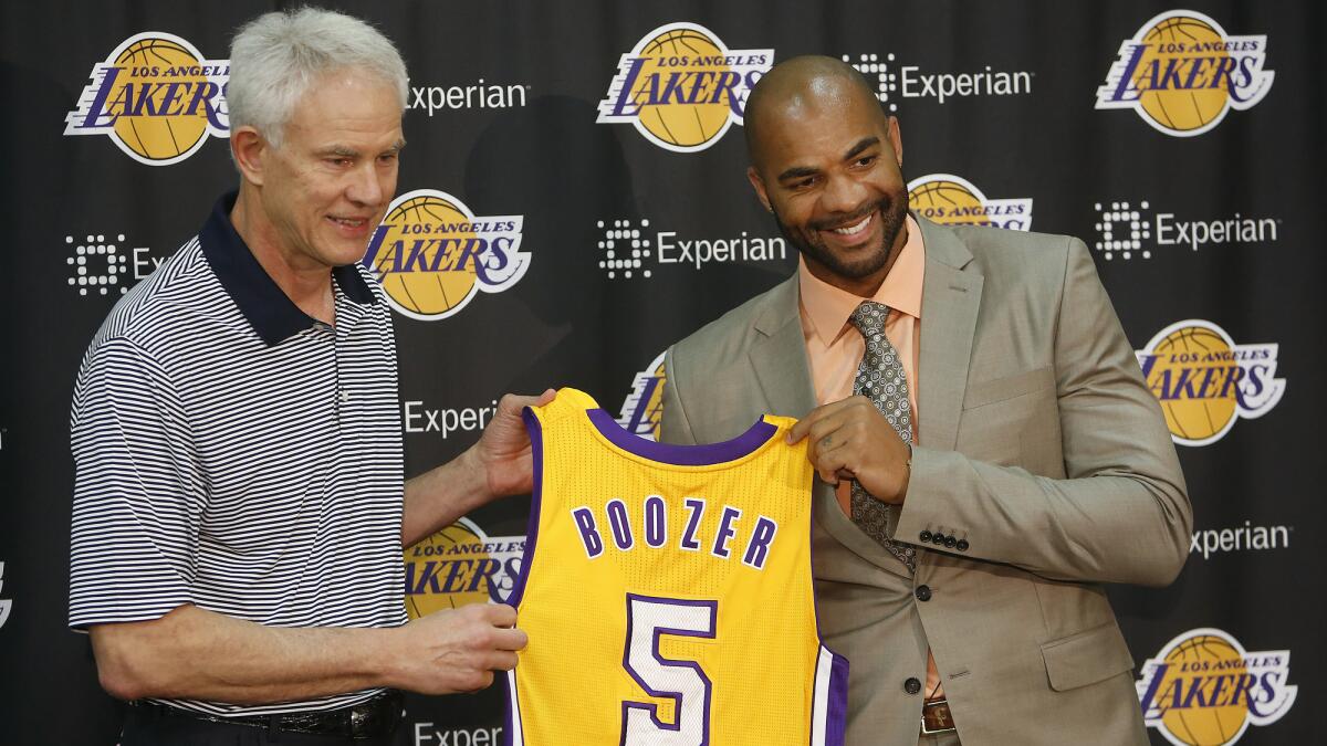Lakers General Manager Mitch Kupchak, left, and Carlos Boozer pose during a news conference at the Lakers' practice facility in El Segundo on Friday.
