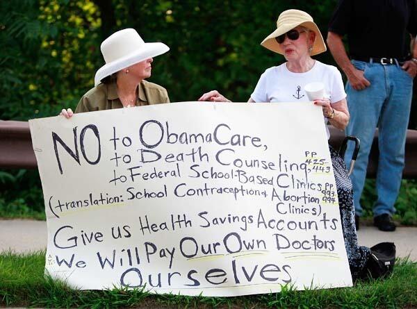 Pat Phillips and Sheila Wahram protest Obama's health plan outside the Towson University Center in Towson, Maryland where a town hall meeting was held August 10, 2009. Their sign cites segments within the Health Reform Bill H.R. 3200 that will be on the table in Congress come fall. Photo: Mark Wilson/Getty Images