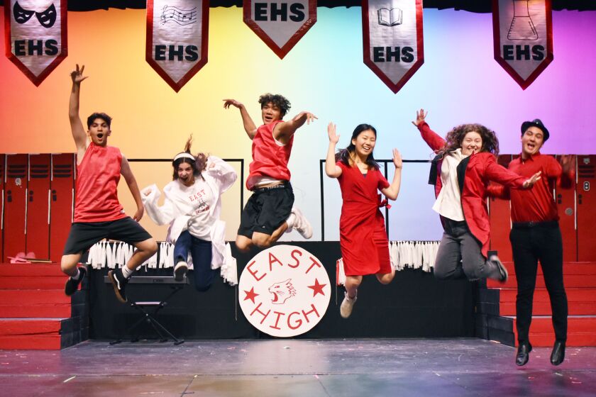 Lead actors in RB High's Disney’s “High School Musical” jumping in the air.