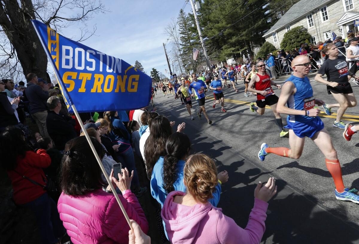 Race fans cheer at the start of the Boston Marathon in Hopkinton, Mass.