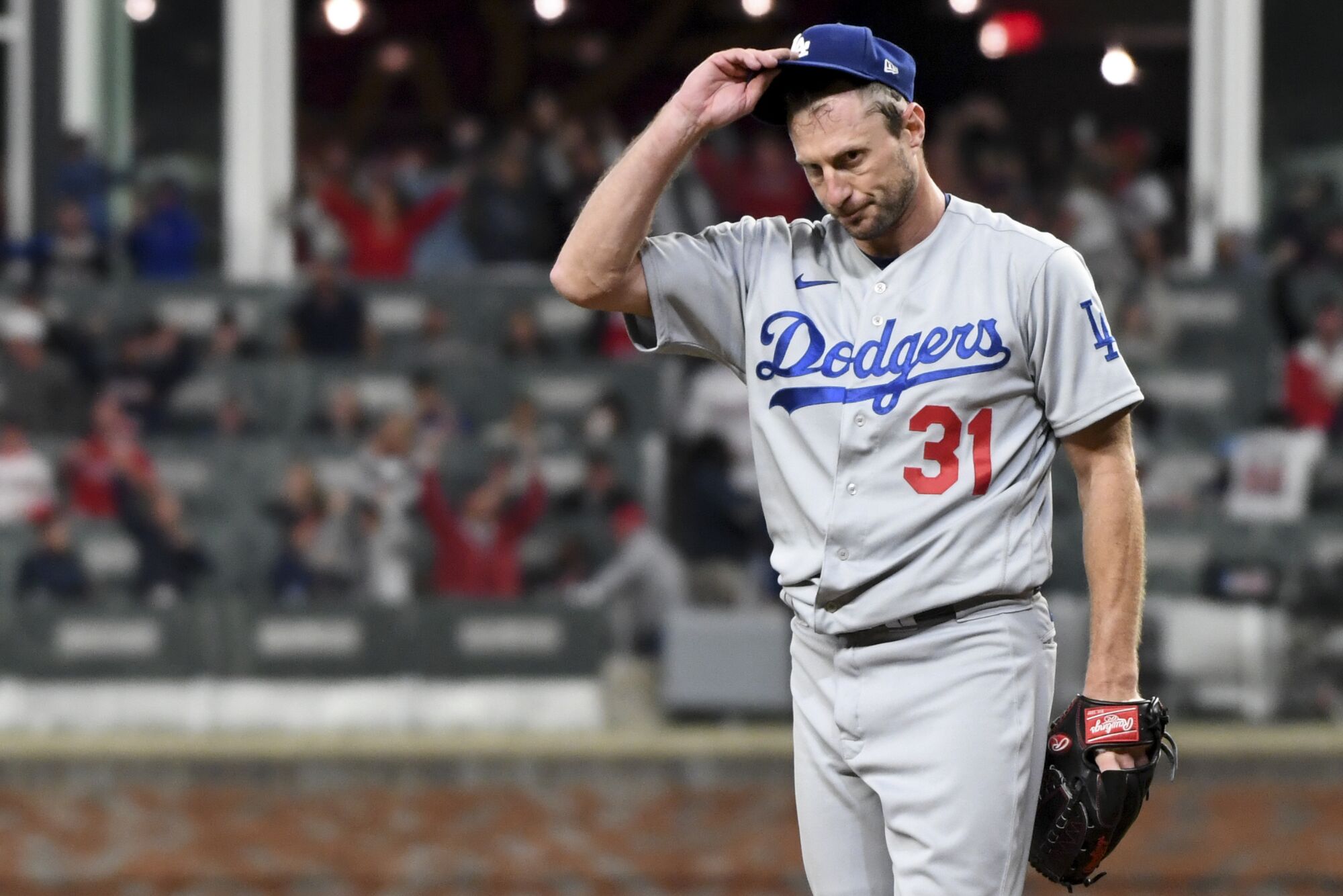 Dodgers starting pitcher Max Scherzer reacts after giving up a two-run home run to Atlanta's Joc Pederson.