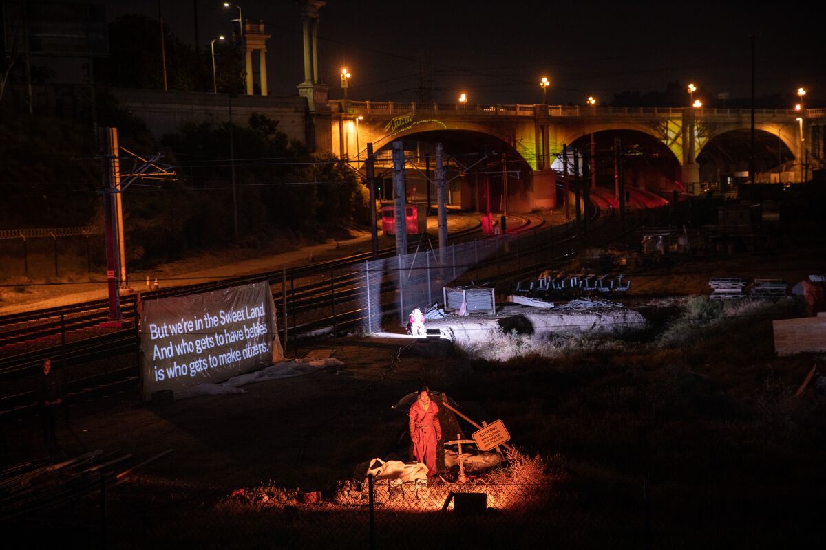 A scene from "Sweet Land" with the North Broadway Bridge in the background