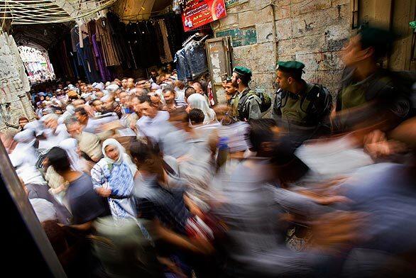 Palestinians walk after praying during the holy fasting month of Ramadan at the Al Aqsa Mosque in Jerusalem's Old City. Muslims throughout the world are celebrating Ramadan, during which observants fast from dawn till dusk.