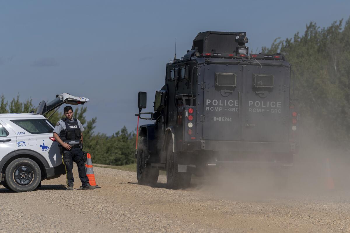 Armored Canadian police vehicle driving past a roadblock