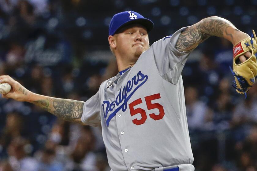 Former Dodgers starting pitcher Mat Latos works against the San Diego Padres during a game on Sept. 3. Latos was signed Monday by the Angels.