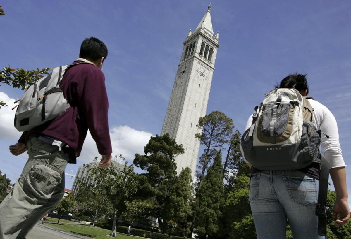 UC Berkeley students walk by Sather Tower on the UC Berkeley campus.