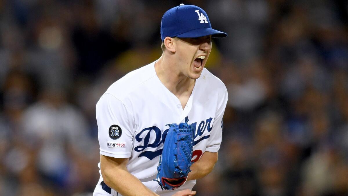 Dodgers pitcher Walker Buehler celebrates a strikeout against the Colorado Rockies to end the top of the ninth inning at Dodger Stadium on Friday night.