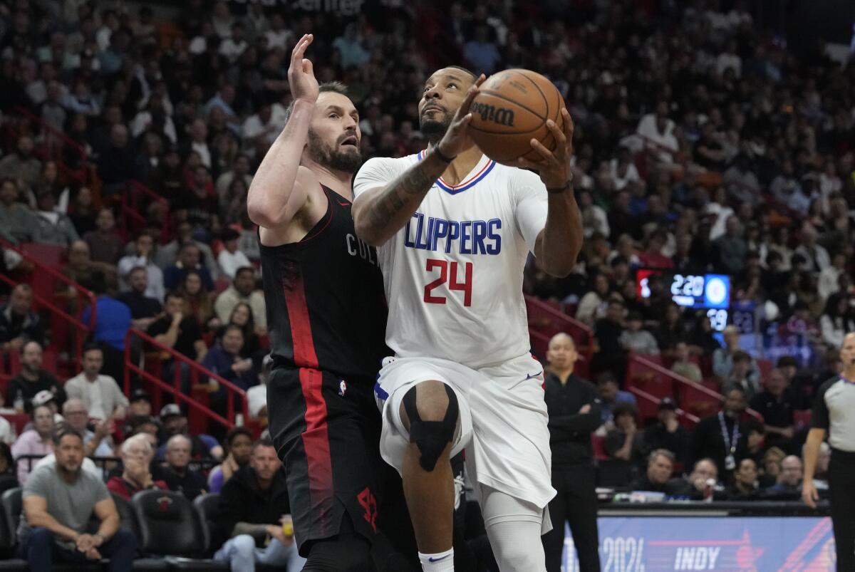 Clippers guard Norman Powell drives to the basket against Kevin Love in the first half.