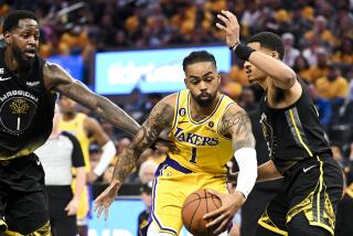 San Francisco, CA - MAY 02: Los Angeles Lakers guard D'Angelo Russell, center, moves the ball between Golden State Warriors forward JaMychal Green, left, and guard Jordan Poole during the second quarter at Chase Center on Tuesday May 2, 2023 in San Francisco, CA.(Wally Skalij / Los Angeles Times)