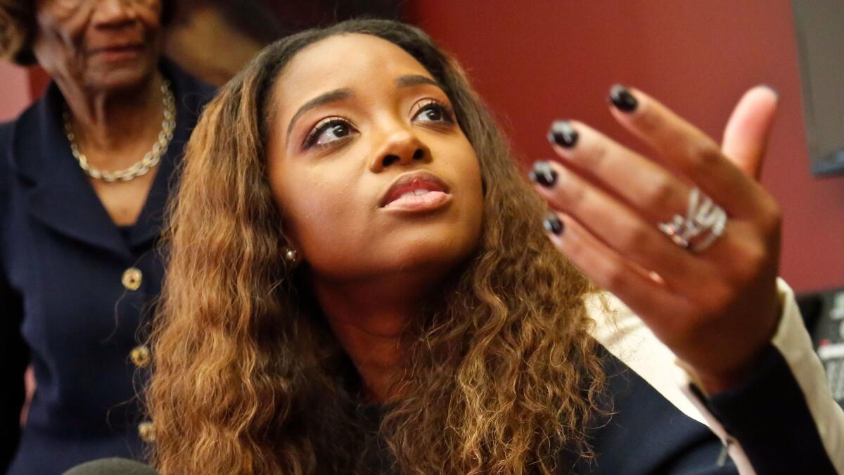 Civil rights activist Tamika Mallory speaks at a news conference in New York. Mallory has accused an American Airlines pilot of racial discrimination for kicking her off a flight.