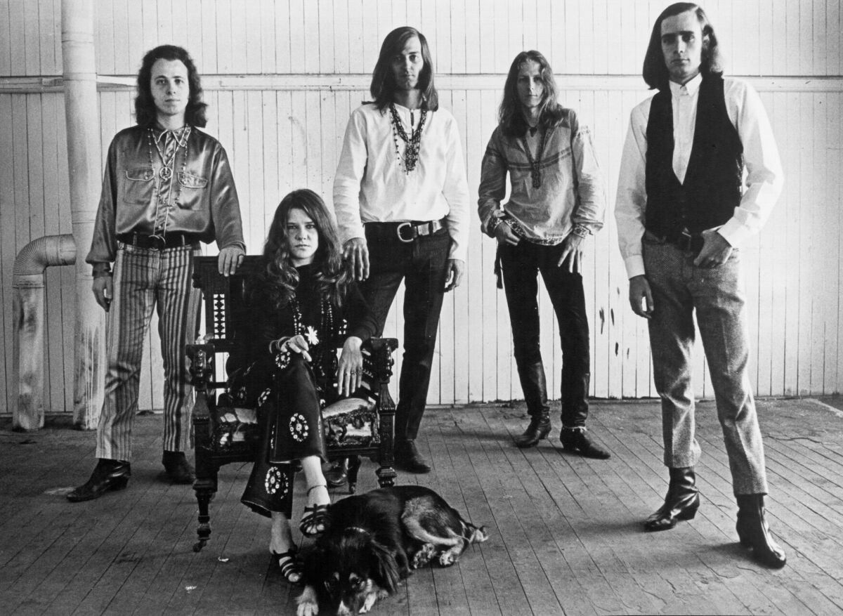Janis Joplin, seated, with Big Brother and the Holding Company in the 1960s — as photographed by Bob Seidemann.