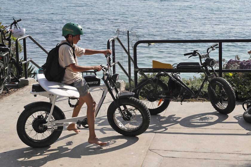 An e-bike rider arrives to the beach on Friday. The Laguna Beach City Council and the Laguna Beach Unified School District held a joint meeting on Thursday evening to discuss the associated safety, education, and enforcement of operating e-bikes.