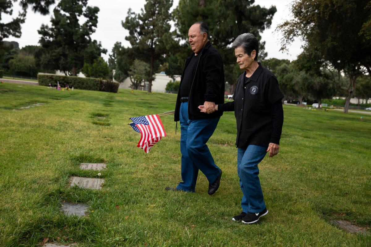 Ruben and Emily Valencia visit the grave site where Raul Guerra, Valencia's best friend, was buried at Rose Hills Memorial Park in Whittier on April 25.